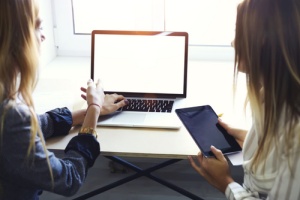 Two women discussing vulnerability testing service solutions